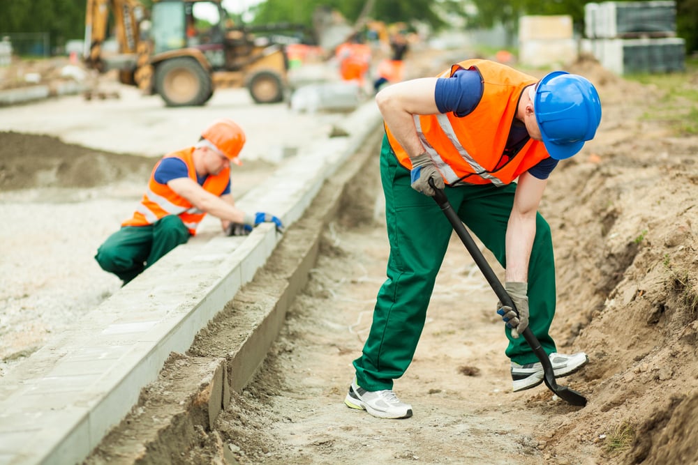 Horizontal image of two builders working hard