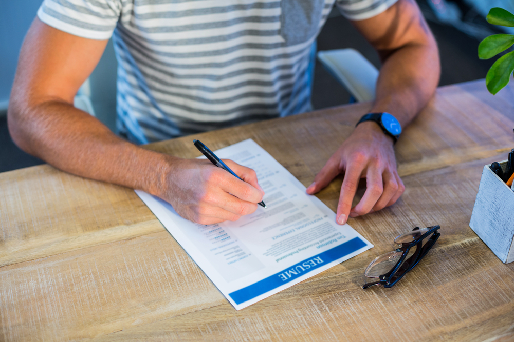 Man at his desk, creating a resume 