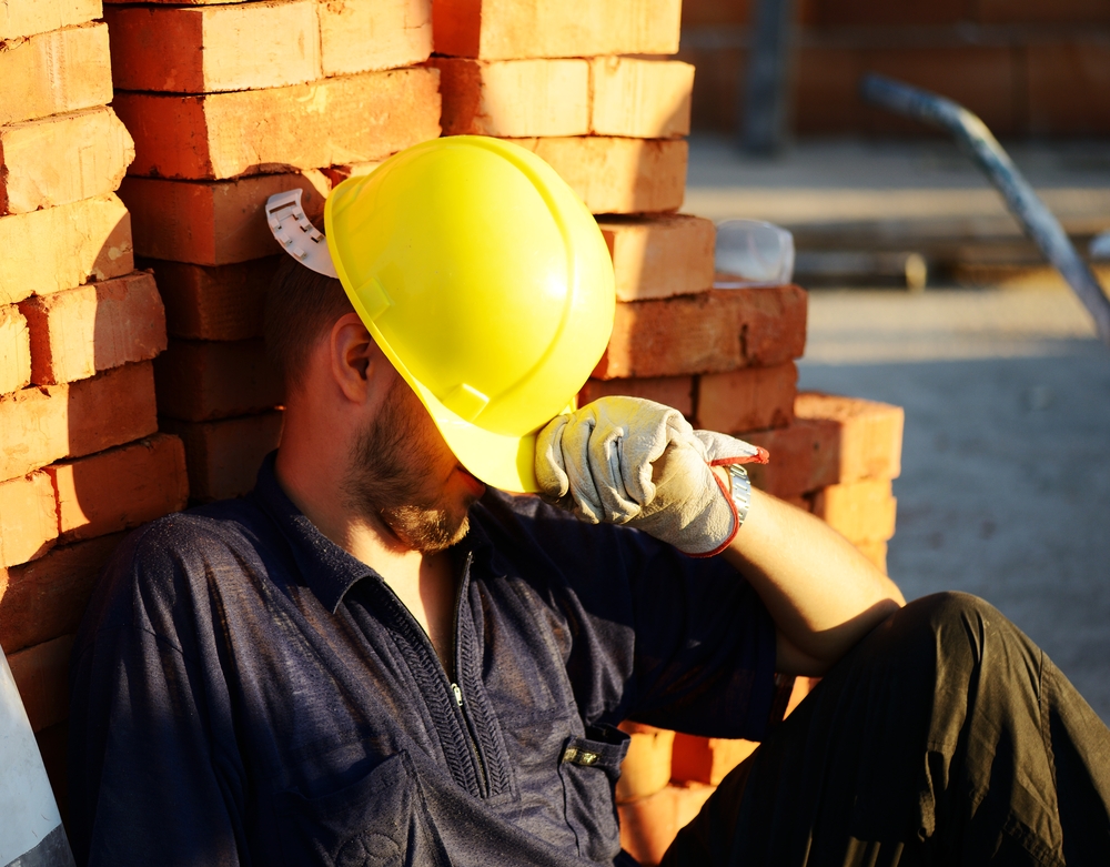 Worker on building construction site in the extreme heat.