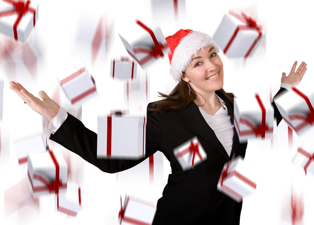 business woman with lots of gifts dropping down over white
