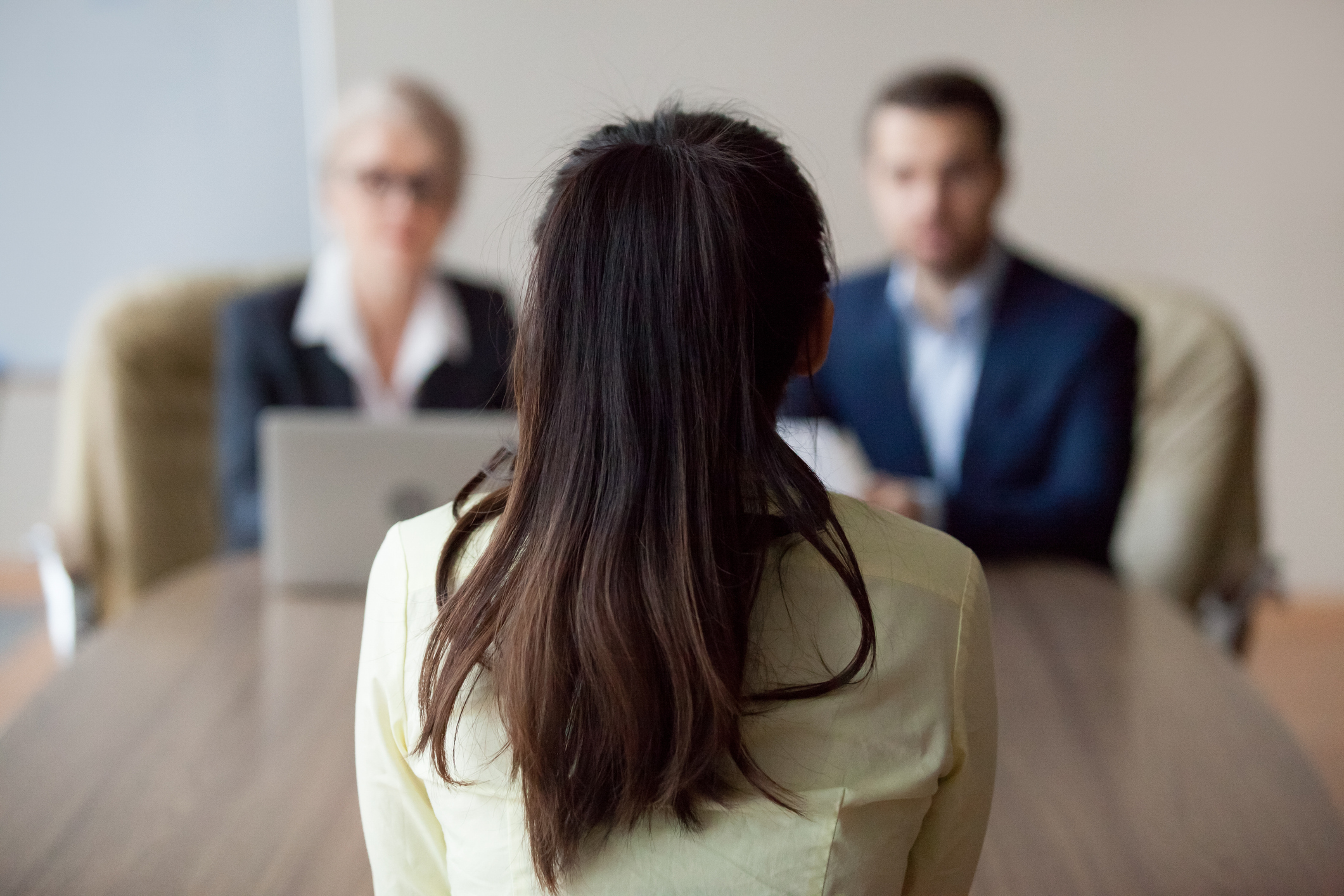 Businesswoman and businessman interviewing woman