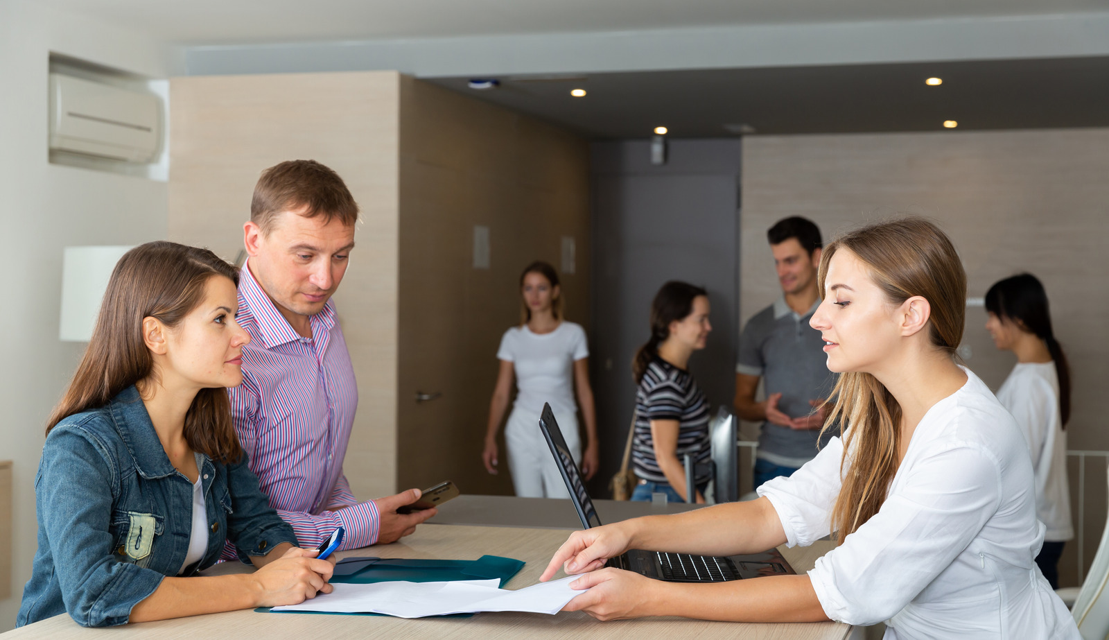 Female employee at staffing agency helping client